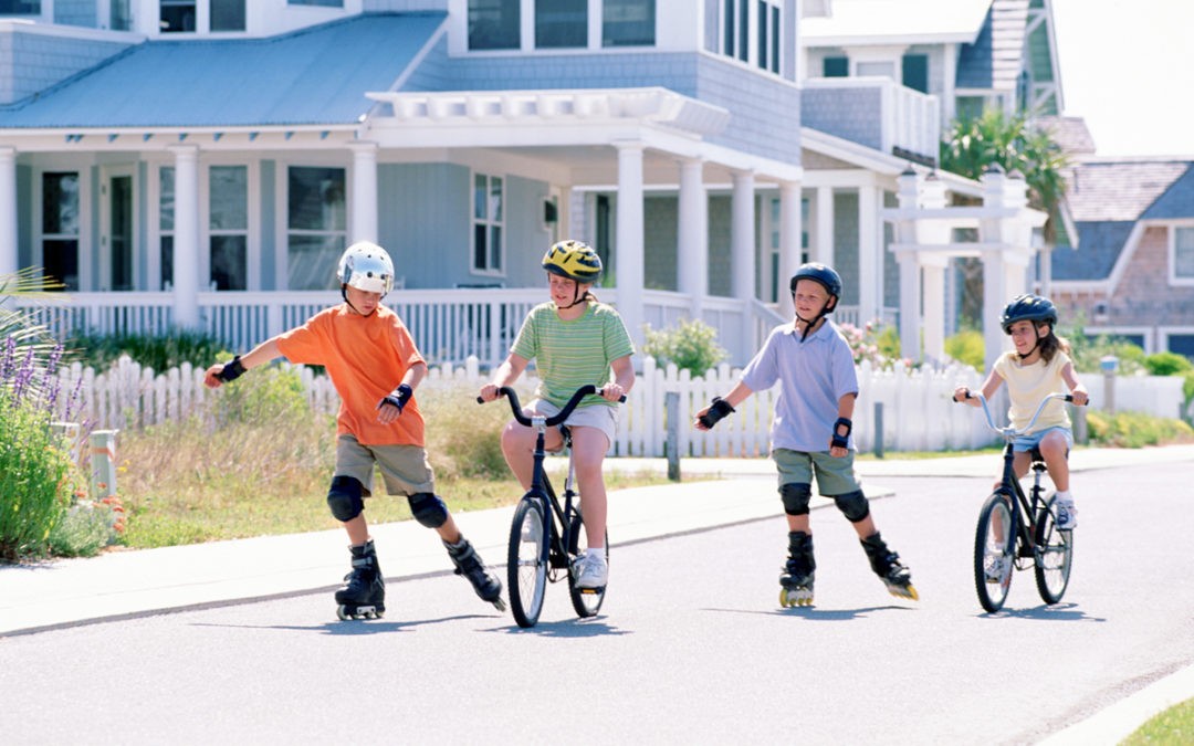 kids-biking-skating-in-neighborhood-86483838-1080x675
