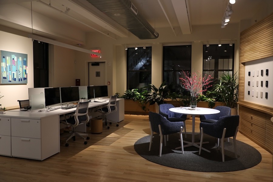 A small office space at night with commercial lighting control.